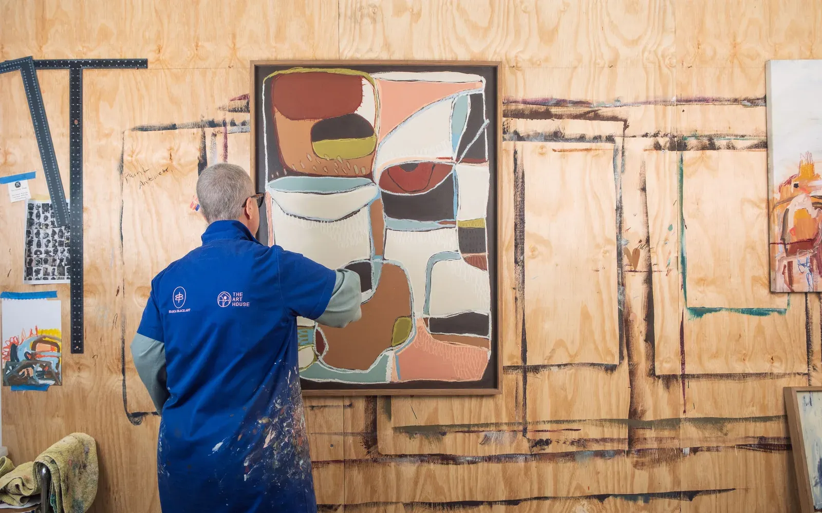 Bianca Black painting in her studio, seen from behind