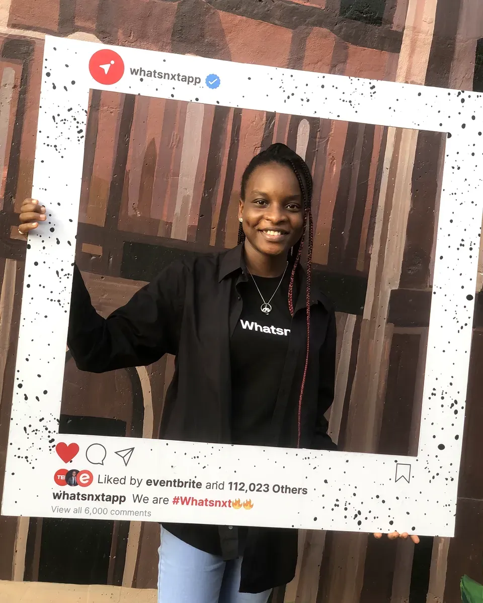 Sidikat holding a Whatsnxt photo frame at the app's launch
